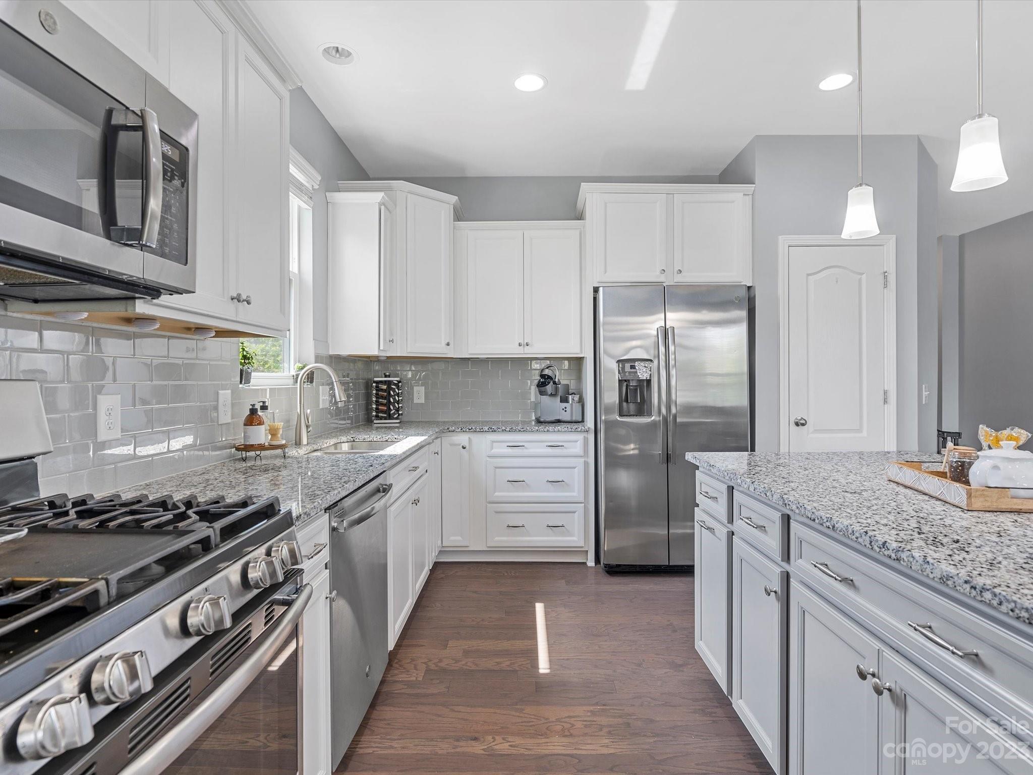 3187 Bridgewater Street Lancaster, SC 29720 - Photo 15 of 37 a kitchen with stainless steel appliances granite countertop a stove a refrigerator and a sink