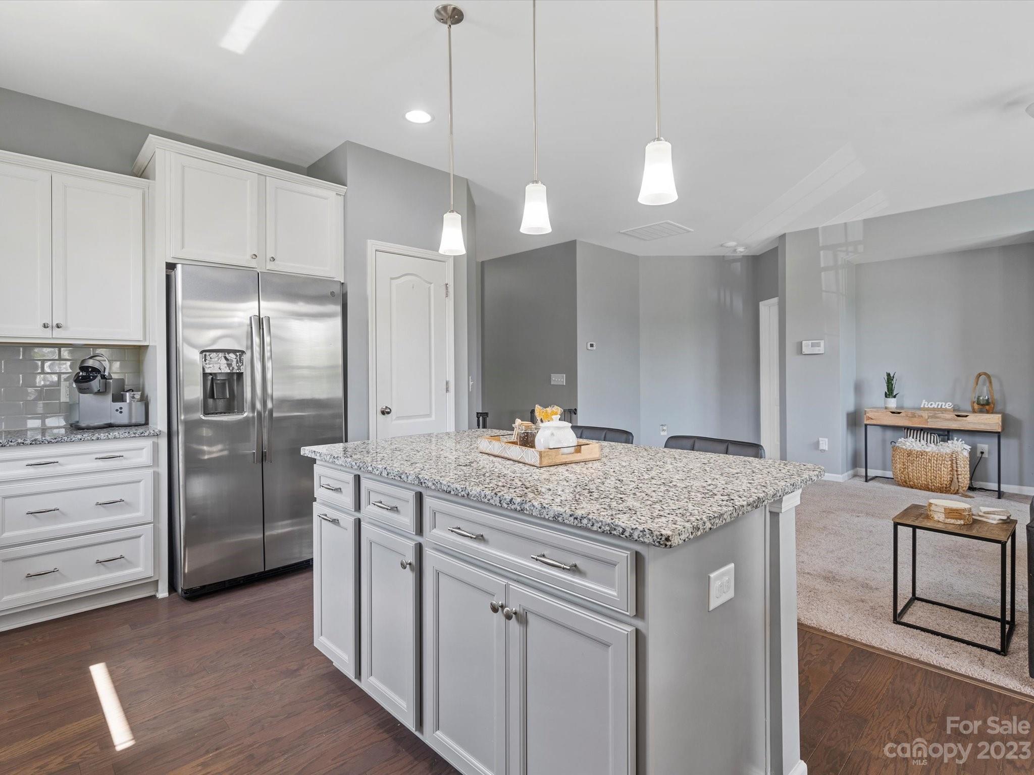 3187 Bridgewater Street Lancaster, SC 29720 - Photo 16 of 37 a kitchen with kitchen island white cabinets and stainless steel appliances