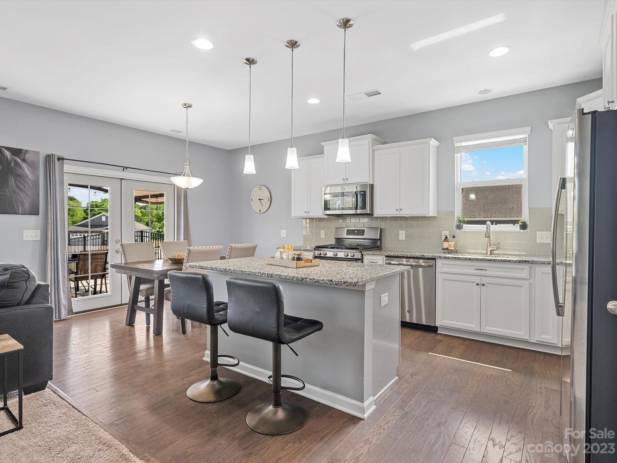 3187 Bridgewater Street Lancaster, SC 29720 - Photo 8 of 37 a kitchen with a dining table chairs sink and cabinets