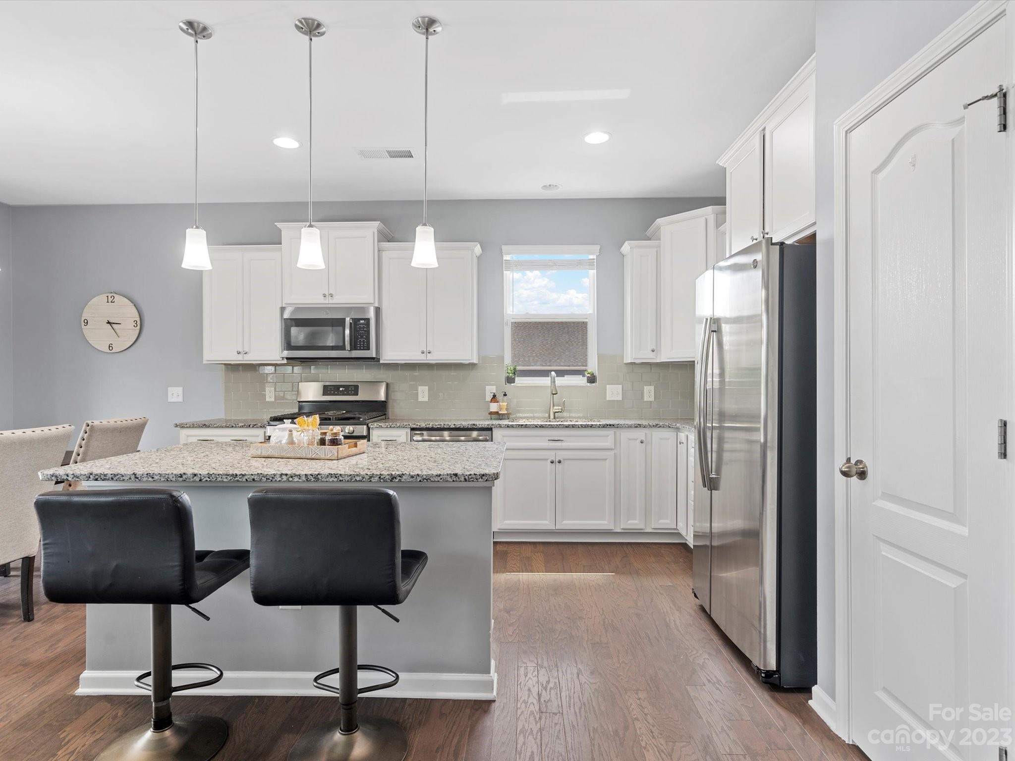 3187 Bridgewater Street Lancaster, SC 29720 - Photo 10 of 37 a kitchen with kitchen island granite countertop a sink cabinets and refrigerator