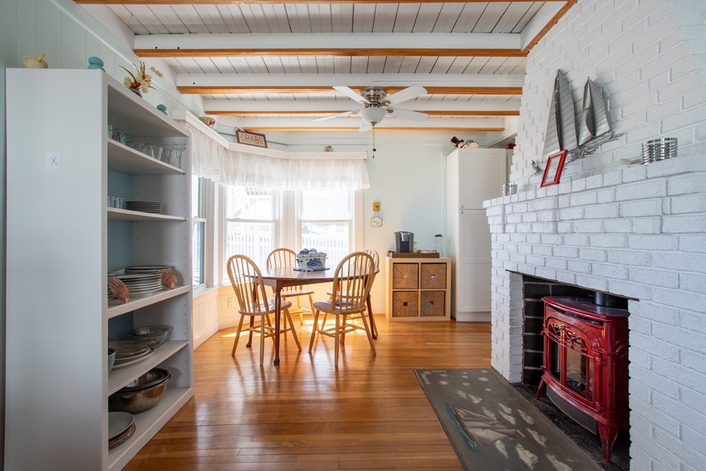 29 Commonwealth Avenue Salisbury, MA 01952 - Photo 13 of 34 a dining room with furniture a fireplace and wooden floor