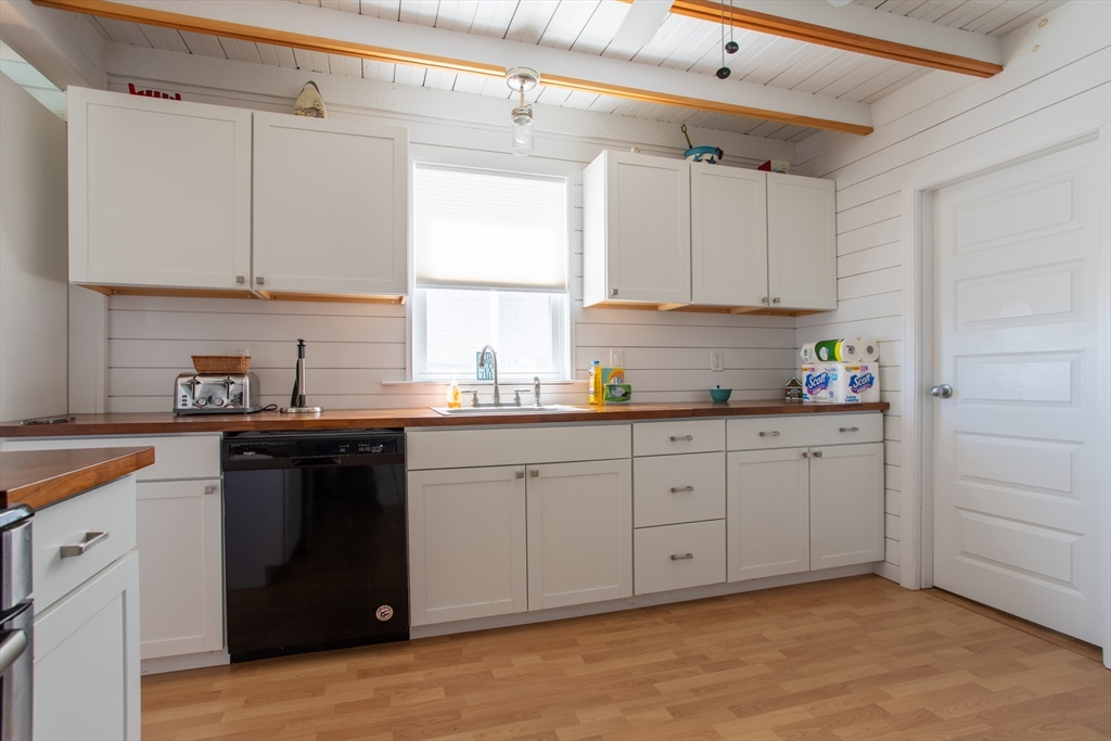29 Commonwealth Avenue Salisbury, MA 01952 - Photo 14 of 34 a kitchen with white cabinets and window