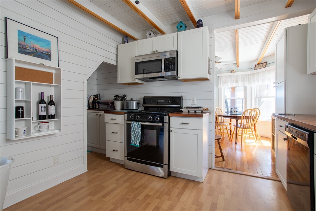 29 Commonwealth Avenue Salisbury, MA 01952 - Photo 16 of 34 a kitchen with stainless steel appliances granite countertop a stove a sink and a microwave