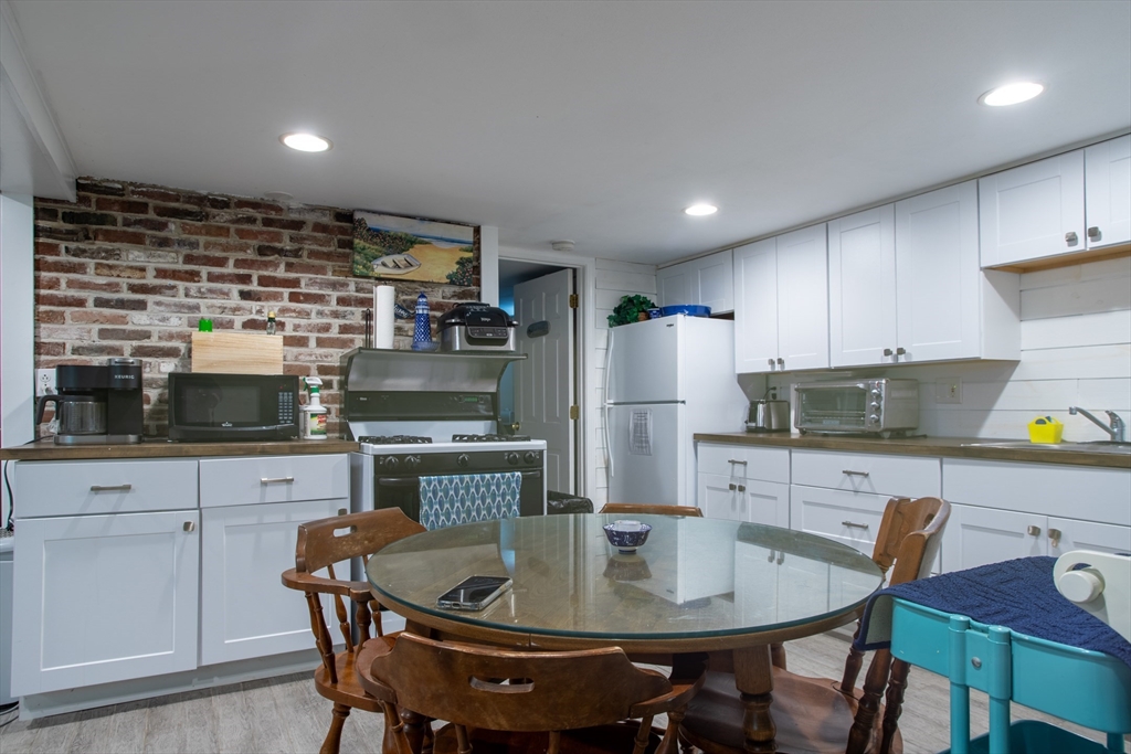 29 Commonwealth Avenue Salisbury, MA 01952 - Photo 24 of 34 a kitchen with a table chairs and refrigerator
