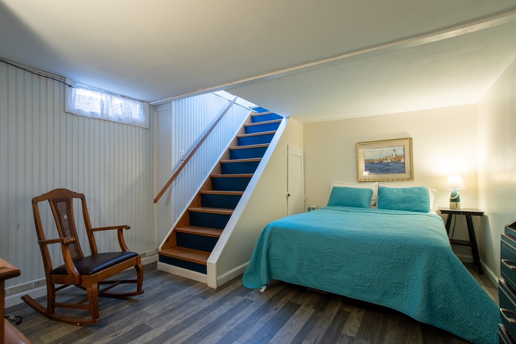 29 Commonwealth Avenue Salisbury, MA 01952 - Photo 25 of 34 a bedroom with a bed and wooden floor