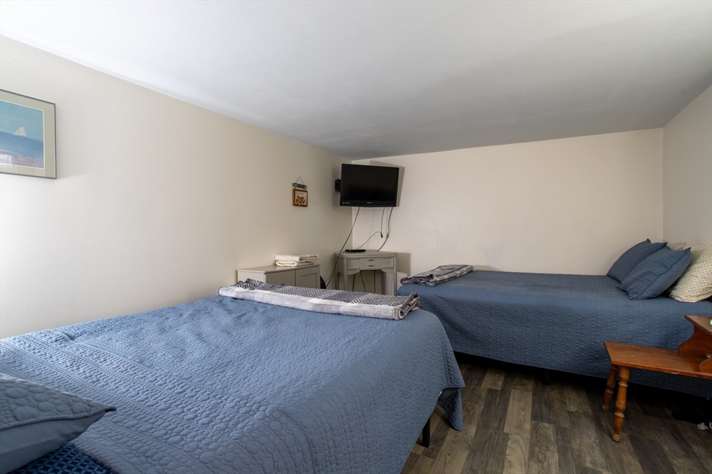 29 Commonwealth Avenue Salisbury, MA 01952 - Photo 26 of 34 a bedroom with a bed and flat screen tv