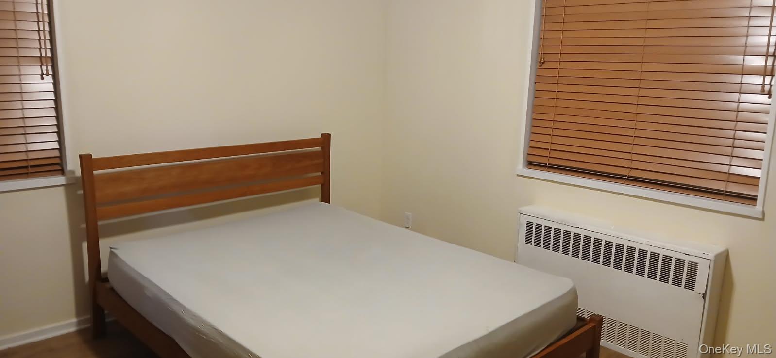 224-04 Manor Road, Unit 103 Queens, NY 11427 - Photo 21 of 28 a bedroom with a bed and a window