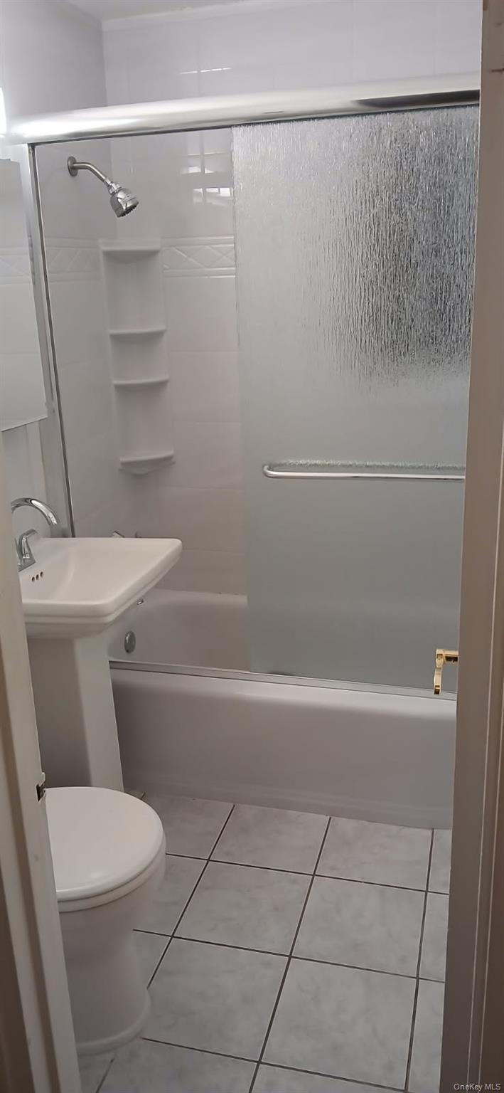 224-04 Manor Road, Unit 103 Queens, NY 11427 - Photo 27 of 28 a white toilet sitting next to a bath tub