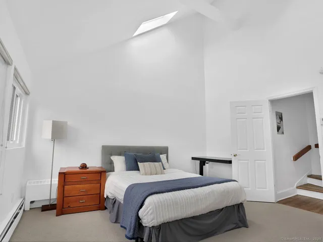 a bedroom with a bed and a night stand