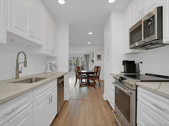 a kitchen with a sink stainless steel appliances and cabinets