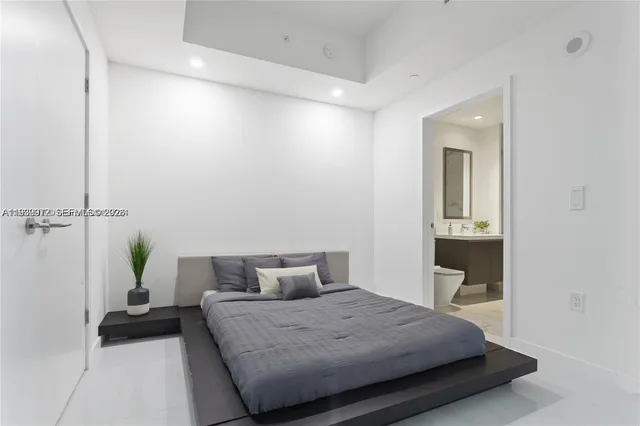 a bedroom with a bed and a table