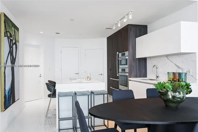a view of a dining room with furniture and a potted plant