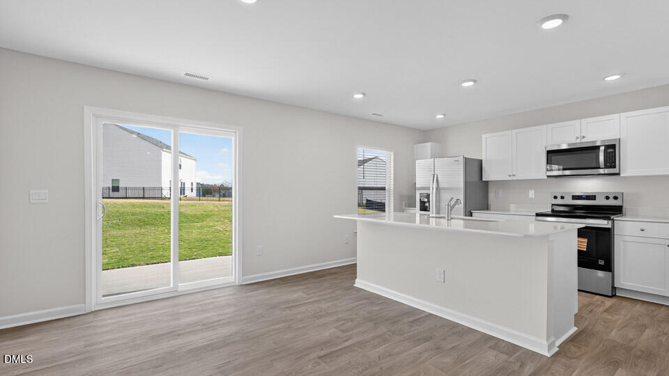 3613 Turney Drive Raleigh, NC 27610 - Photo 13 of 39 a kitchen with stainless steel appliances a refrigerator sink and microwave
