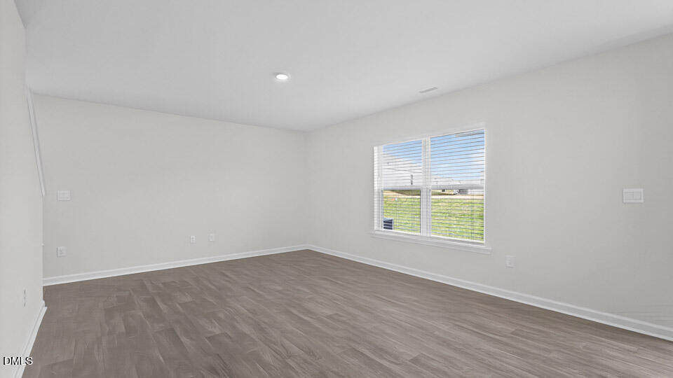 3613 Turney Drive Raleigh, NC 27610 - Photo 14 of 39 an empty room with wooden floor and windows