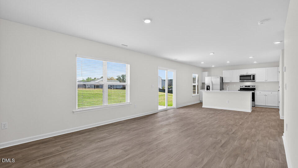 3613 Turney Drive Raleigh, NC 27610 - Photo 16 of 39 a view of an empty room with a window and wooden floor