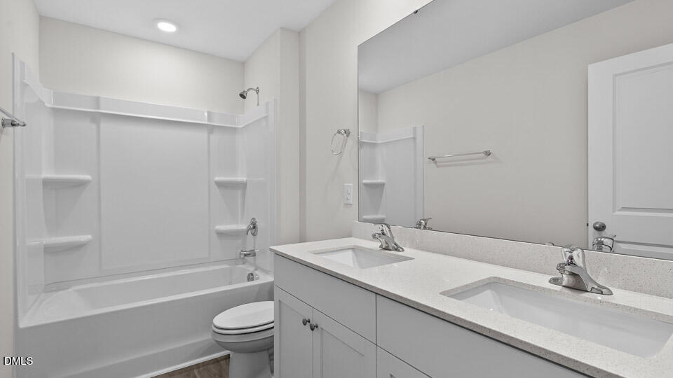 3613 Turney Drive Raleigh, NC 27610 - Photo 23 of 39 a bathroom with a sink a toilet and shower