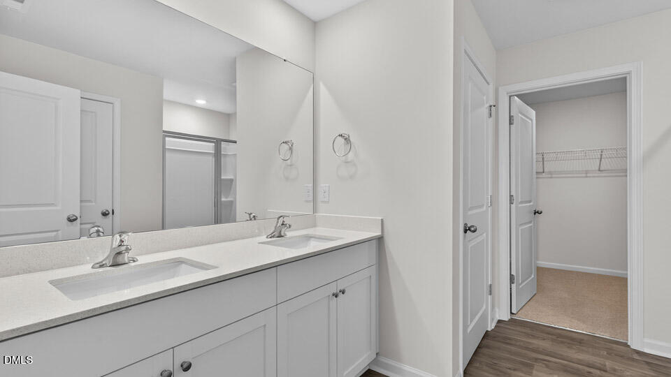 3613 Turney Drive Raleigh, NC 27610 - Photo 28 of 39 a bathroom with a sink double vanity and a mirror