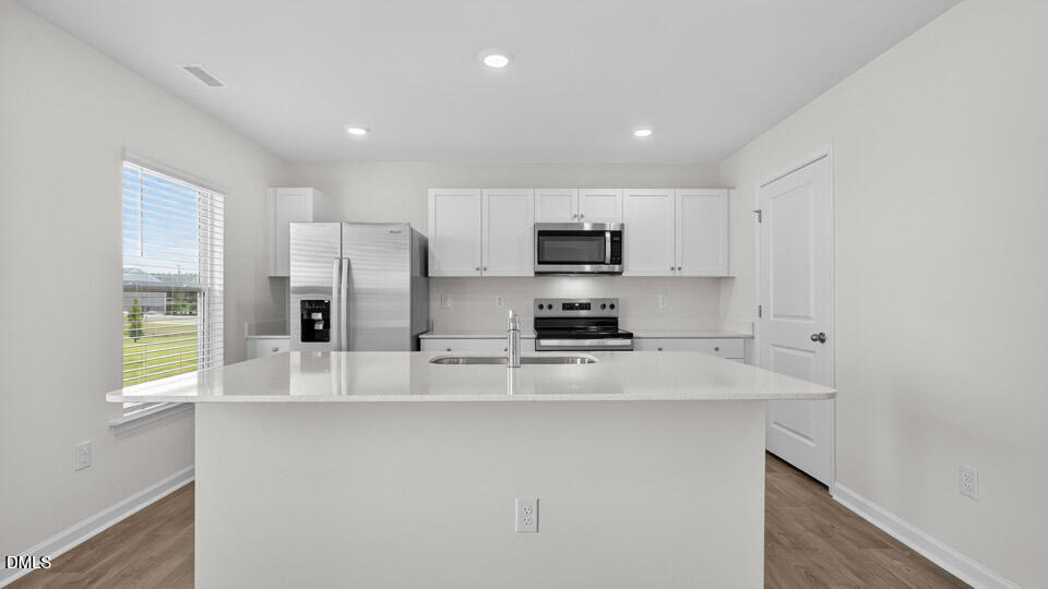 3613 Turney Drive Raleigh, NC 27610 - Photo 9 of 39 a kitchen with stainless steel appliances a refrigerator sink and microwave