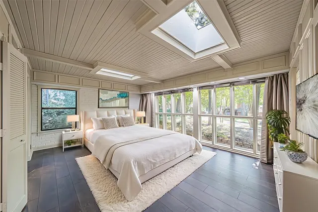 a bedroom with a large bed and a large window