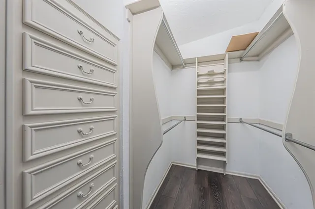 a view of walk in closet with empty racks