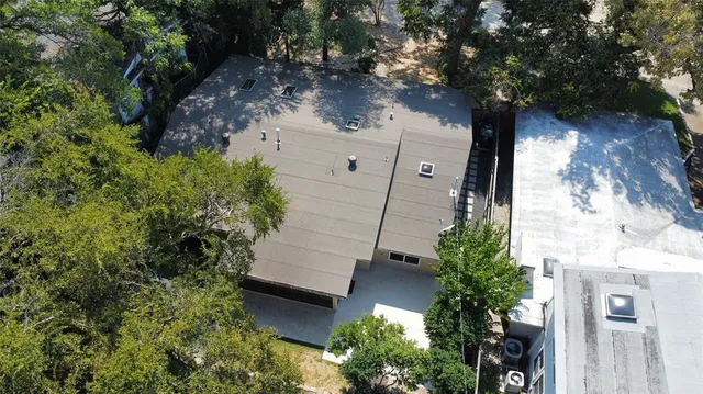 an aerial view of a house with outdoor space
