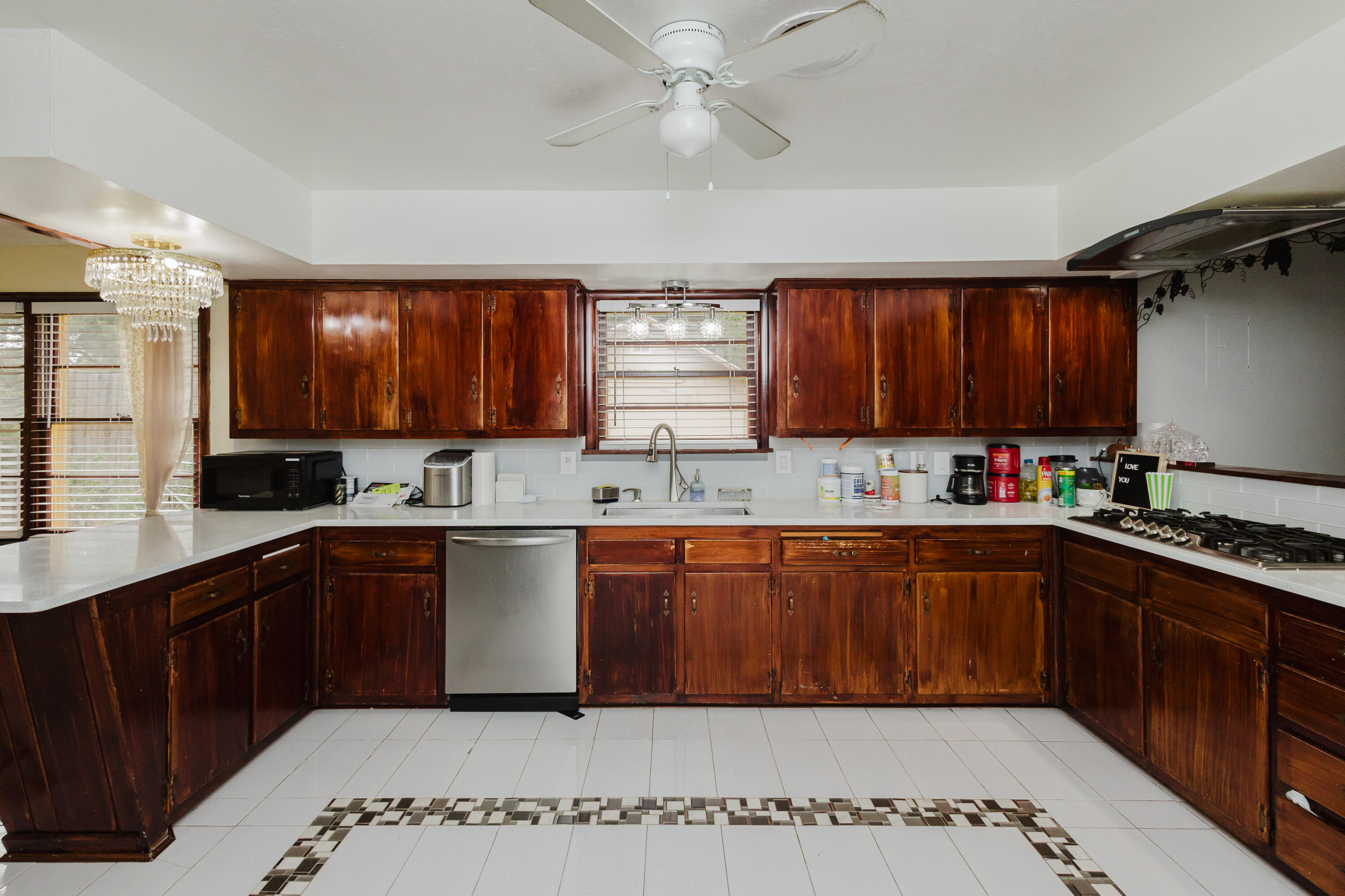 2110 57th Street Lubbock, TX 79412 - Photo 16 of 49 a kitchen with stainless steel appliances granite countertop wooden cabinets a sink and dishwasher a oven with wooden cabinets