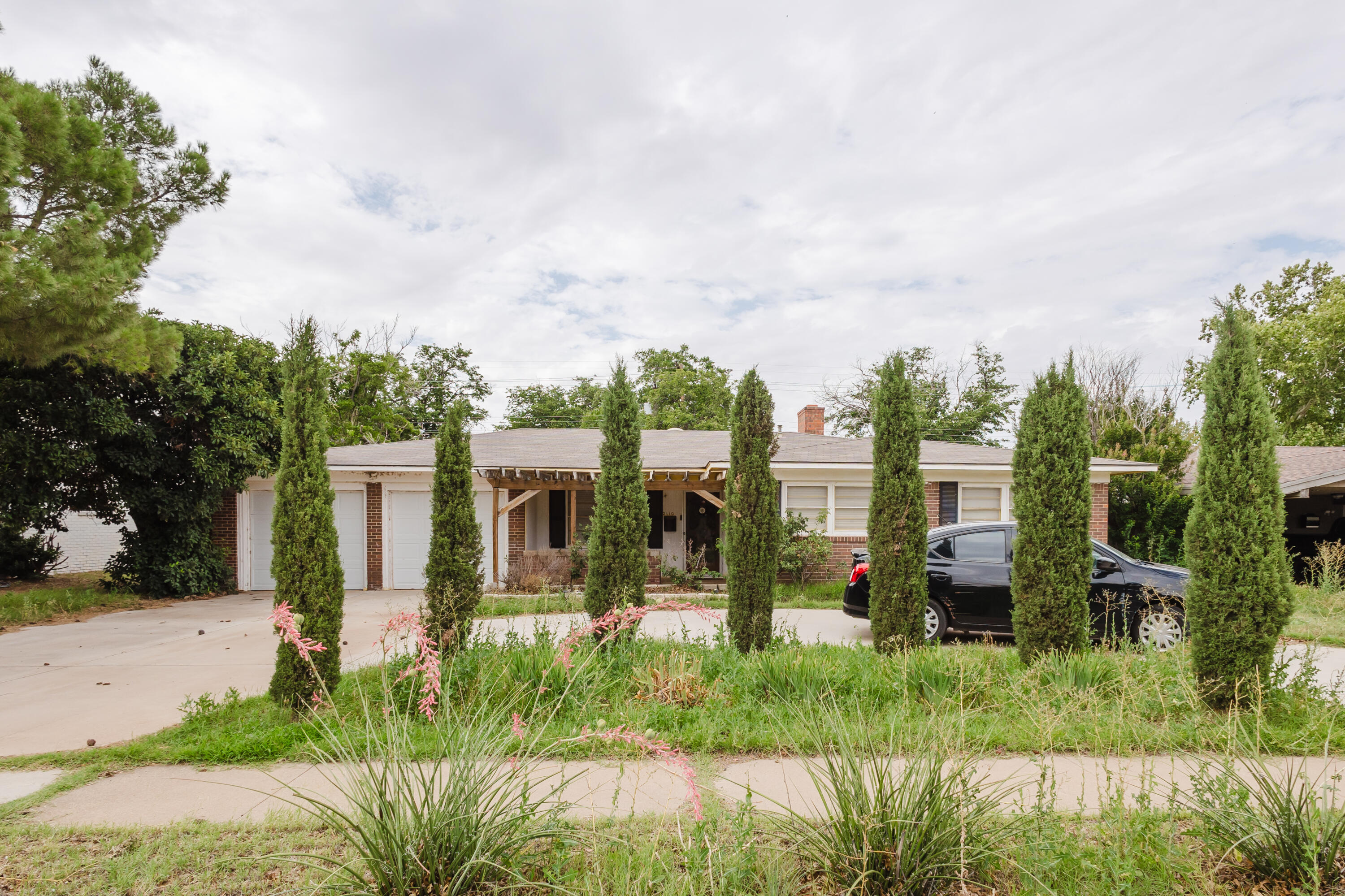 2110 57th Street Lubbock, TX 79412 - Photo 2 of 49 a view of a house with garden and plants