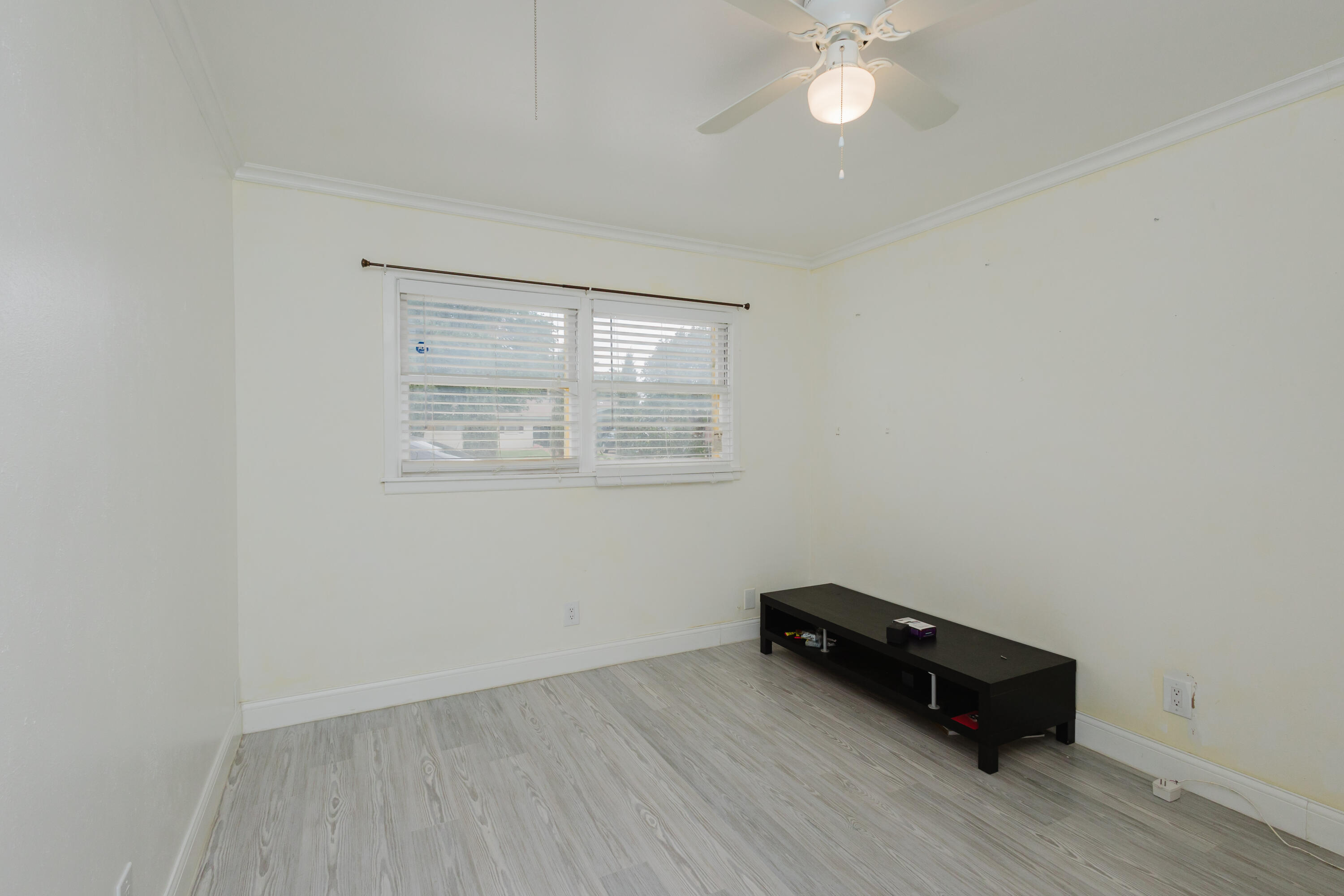 2110 57th Street Lubbock, TX 79412 - Photo 22 of 49 an empty room with wooden floor and windows