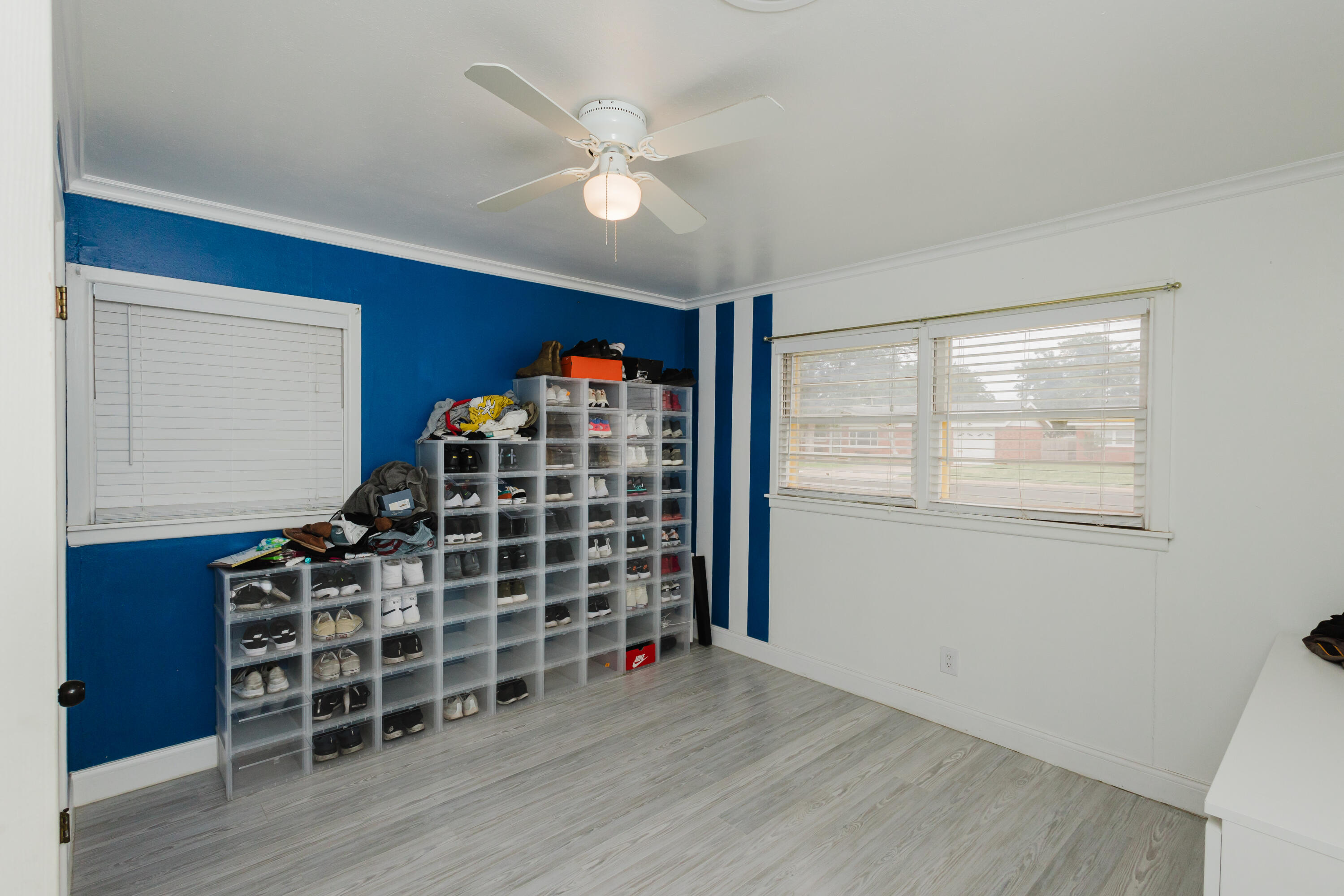 2110 57th Street Lubbock, TX 79412 - Photo 26 of 49 a view of an empty room with a window and wooden floor