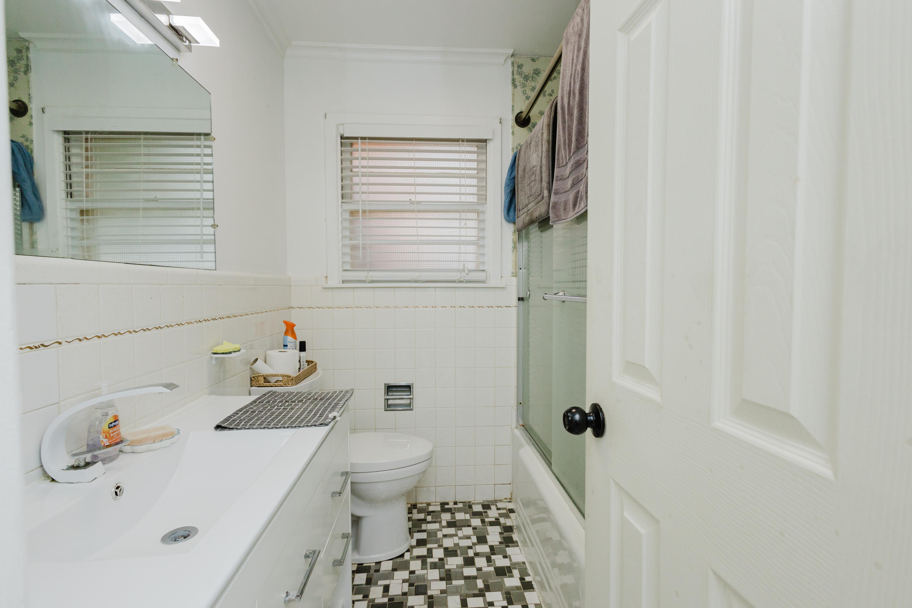 2110 57th Street Lubbock, TX 79412 - Photo 31 of 49 a bathroom with a sink a toilet and shower curtain