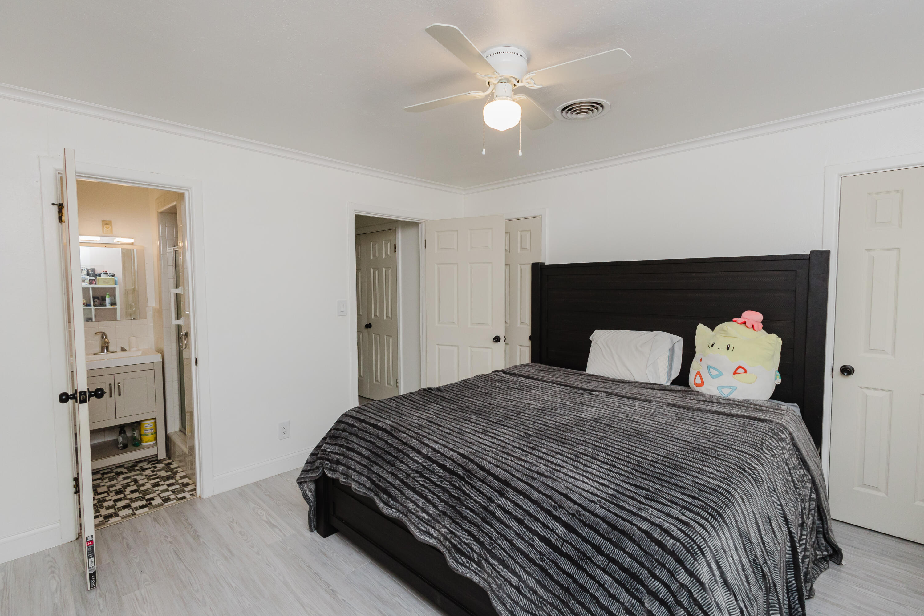 2110 57th Street Lubbock, TX 79412 - Photo 35 of 49 a bedroom with a bed and wooden floor