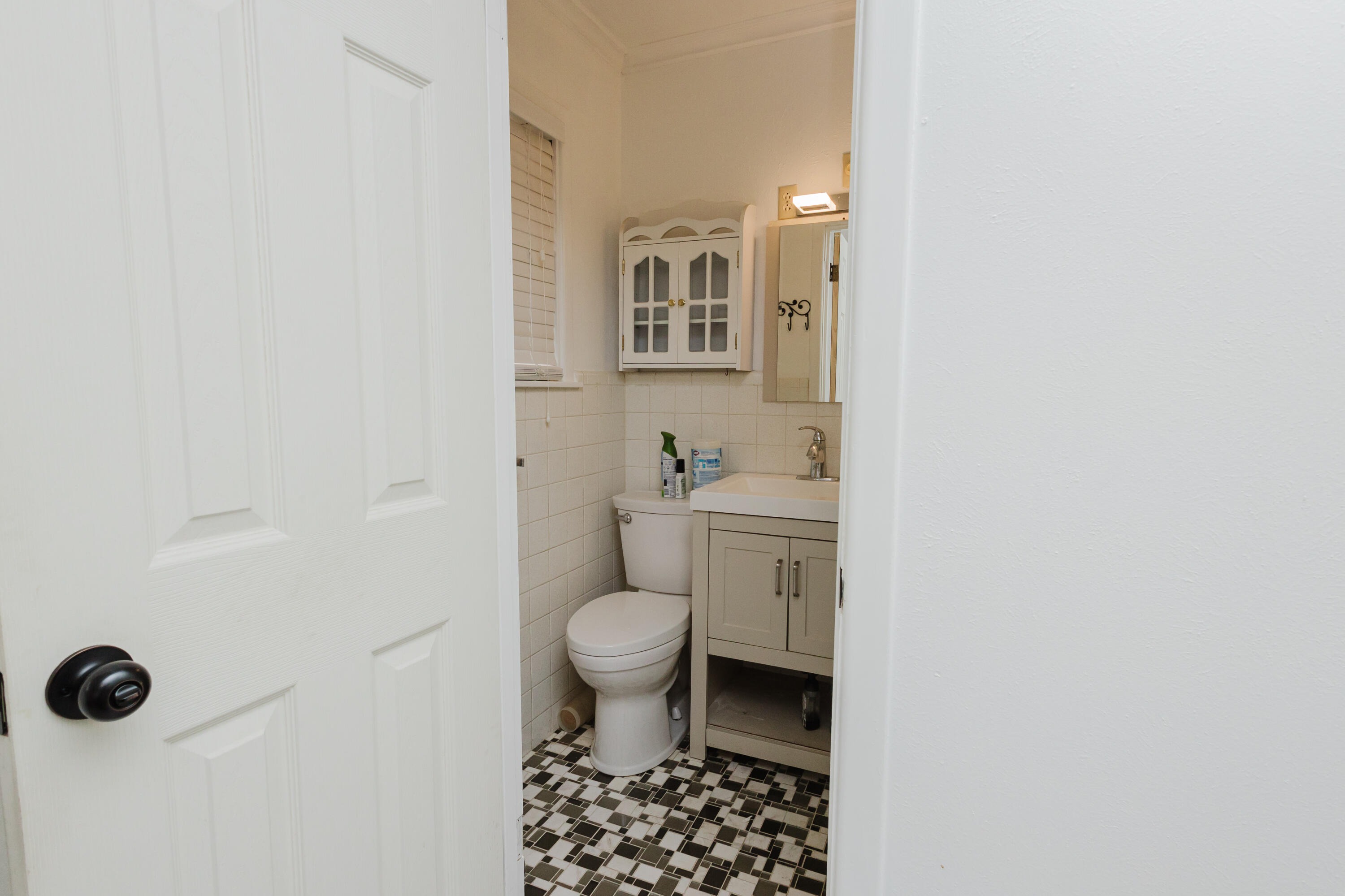 2110 57th Street Lubbock, TX 79412 - Photo 37 of 49 a bathroom with a toilet a sink and a mirror