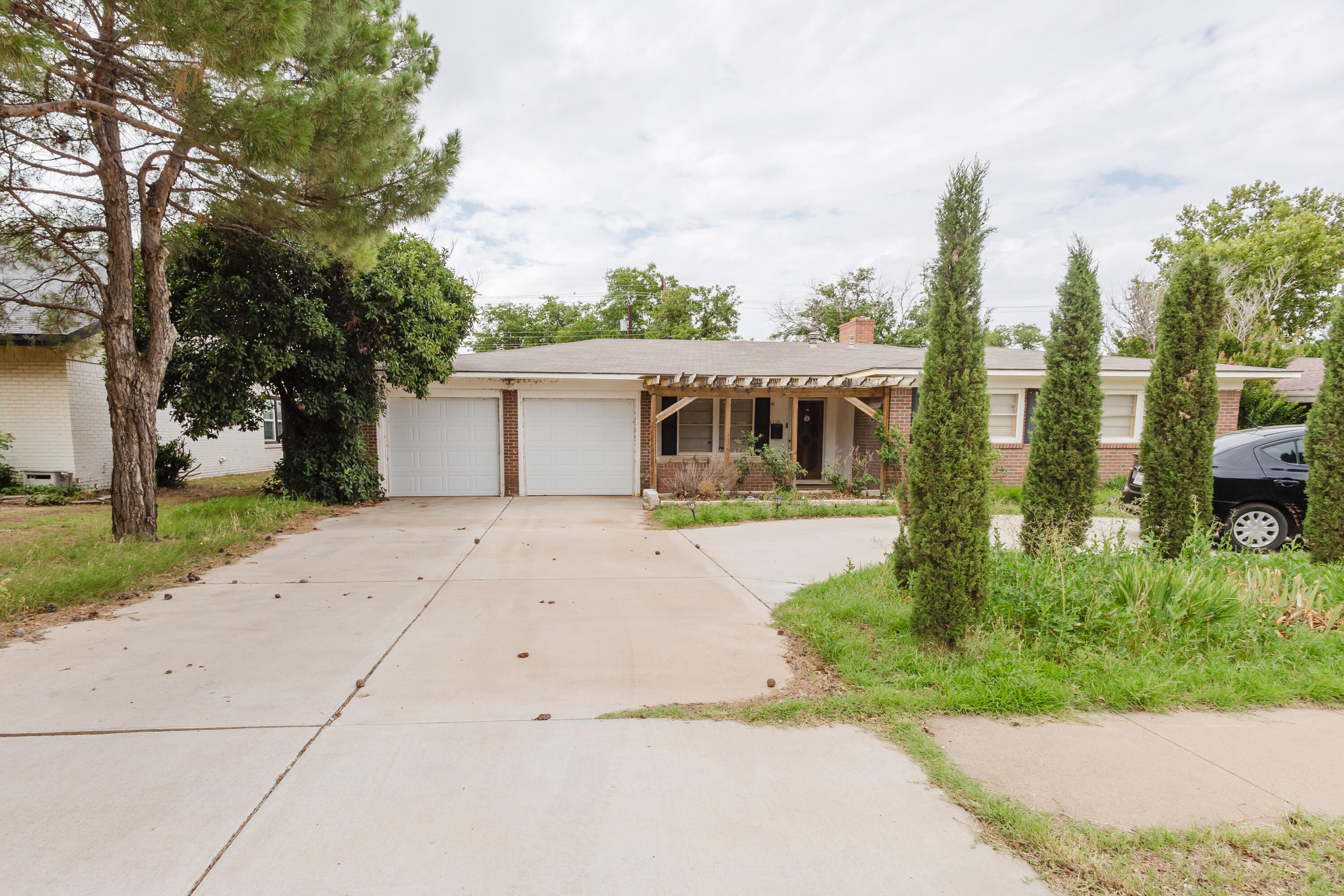 2110 57th Street Lubbock, TX 79412 - Photo 4 of 49 a front view of a house with a yard and trees