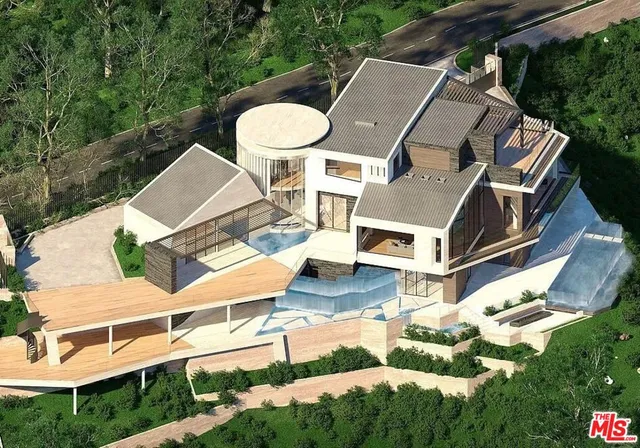 an aerial view of a house with backyard space and balcony