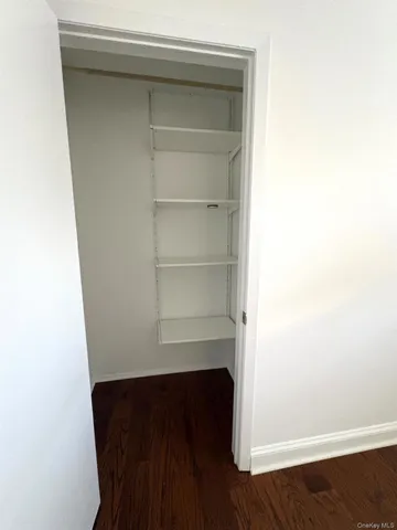 a room with a bench and wooden floor