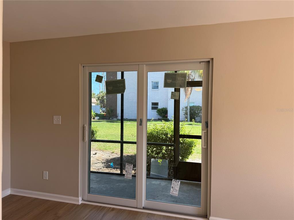 5521 Bay Boulevard, Unit 105 Port Richey, FL 34668 - Photo 7 of 15 a view of a glass door and a living room