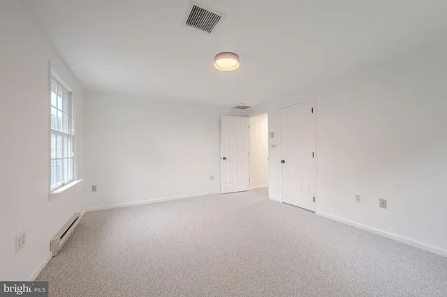 an empty room with windows and window