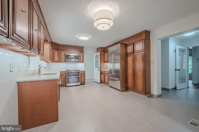 a kitchen with stainless steel appliances granite countertop a refrigerator and stove