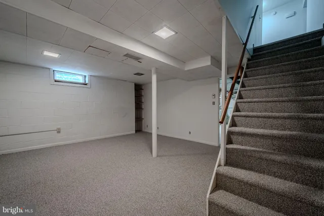 a view of an empty room with stairs