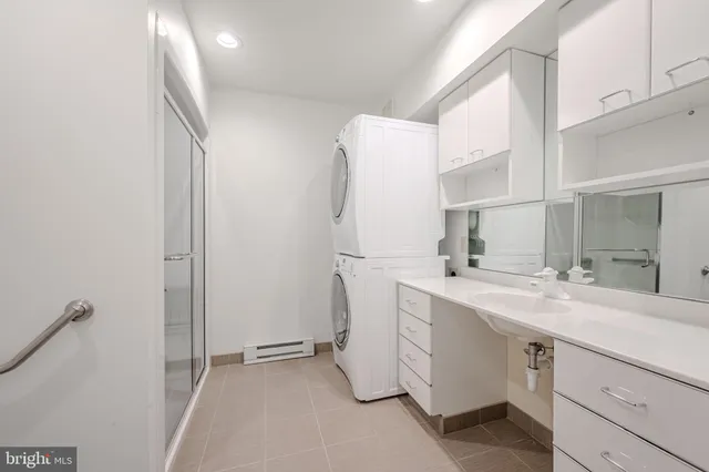 a utility room with cabinets washer and dryer