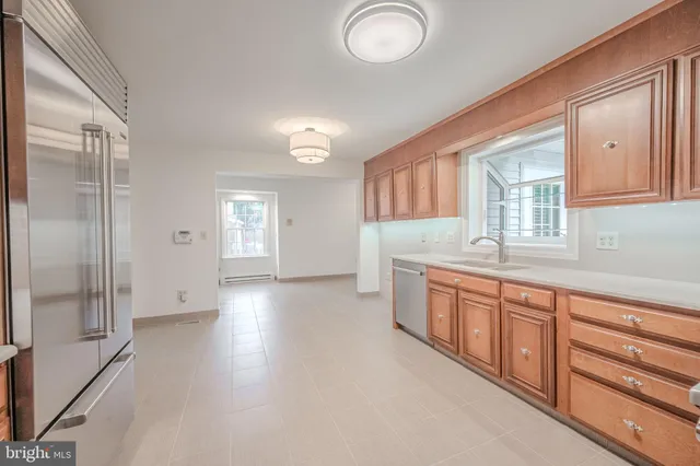 a large kitchen with granite countertop a large window