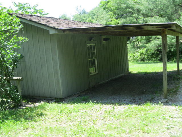 6294 Dillons Mill Road Callaway, VA 24067 - Photo 21 of 23 a backyard of a house with a garden and plants
