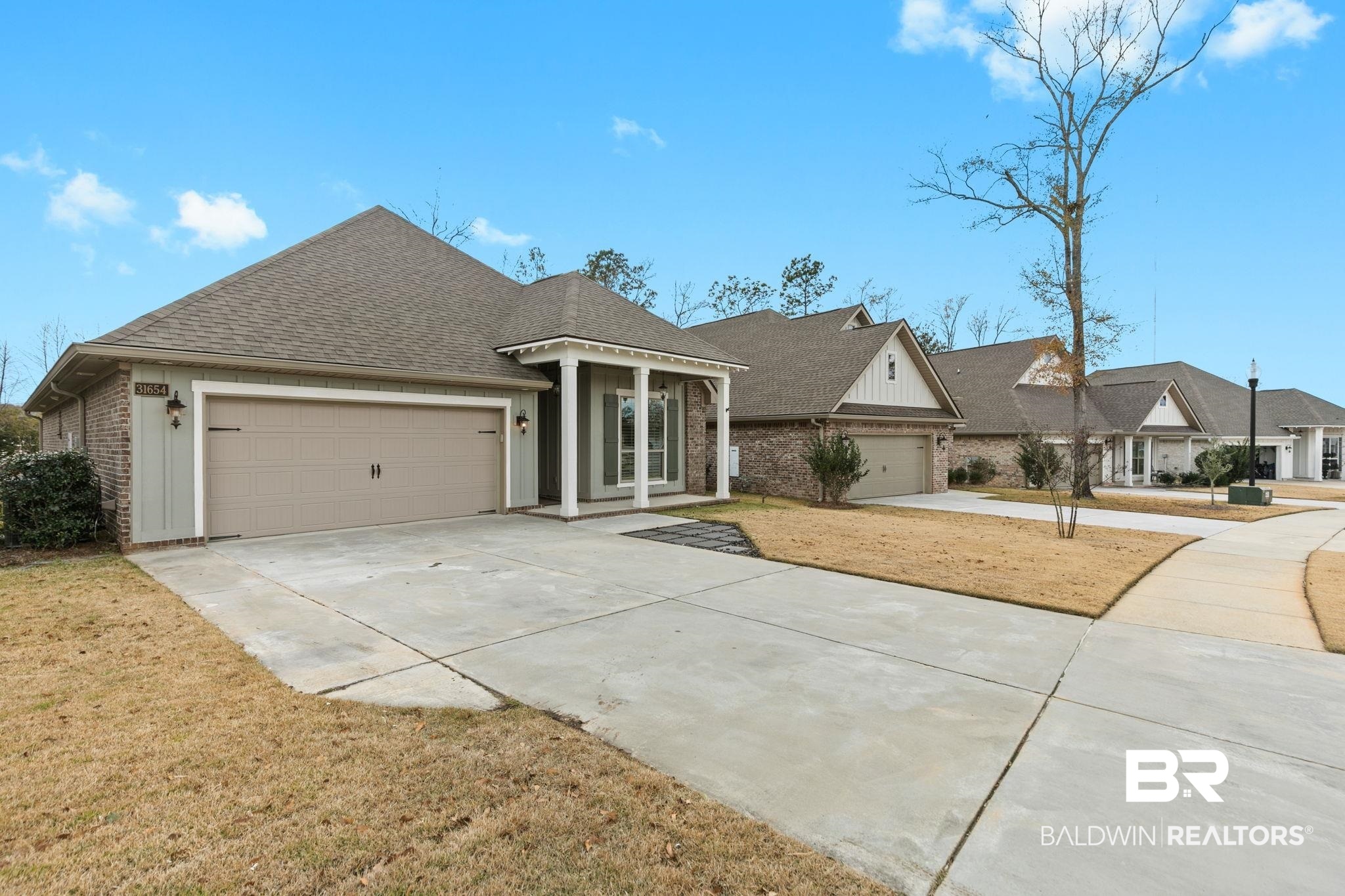 31654 Canopy Loop Daphne, AL 36527 - Photo 5 of 64 View of front facade featuring a shingled roof, driveway, an attached garage, and brick siding