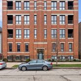 a buildings and cars parked in front of a building