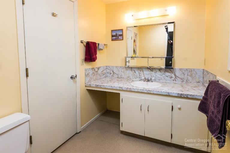 61839 Dobbin Road Bend, OR 97702 - Photo 3 of 23 a bathroom with a granite countertop sink and a mirror