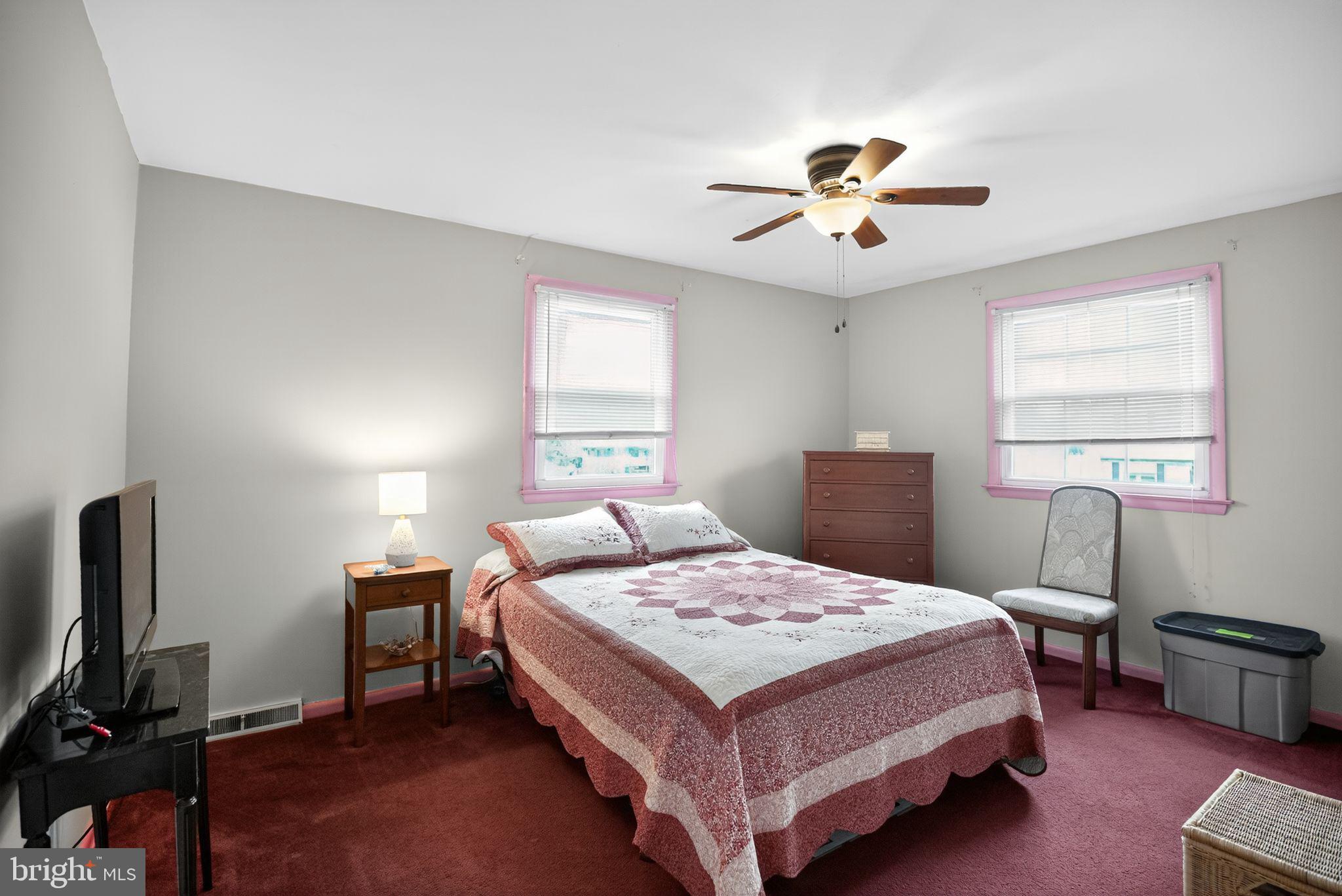 1009 Twist Road Philadelphia, PA 19115 - Photo 23 of 30 a bedroom with a bed and a chandelier