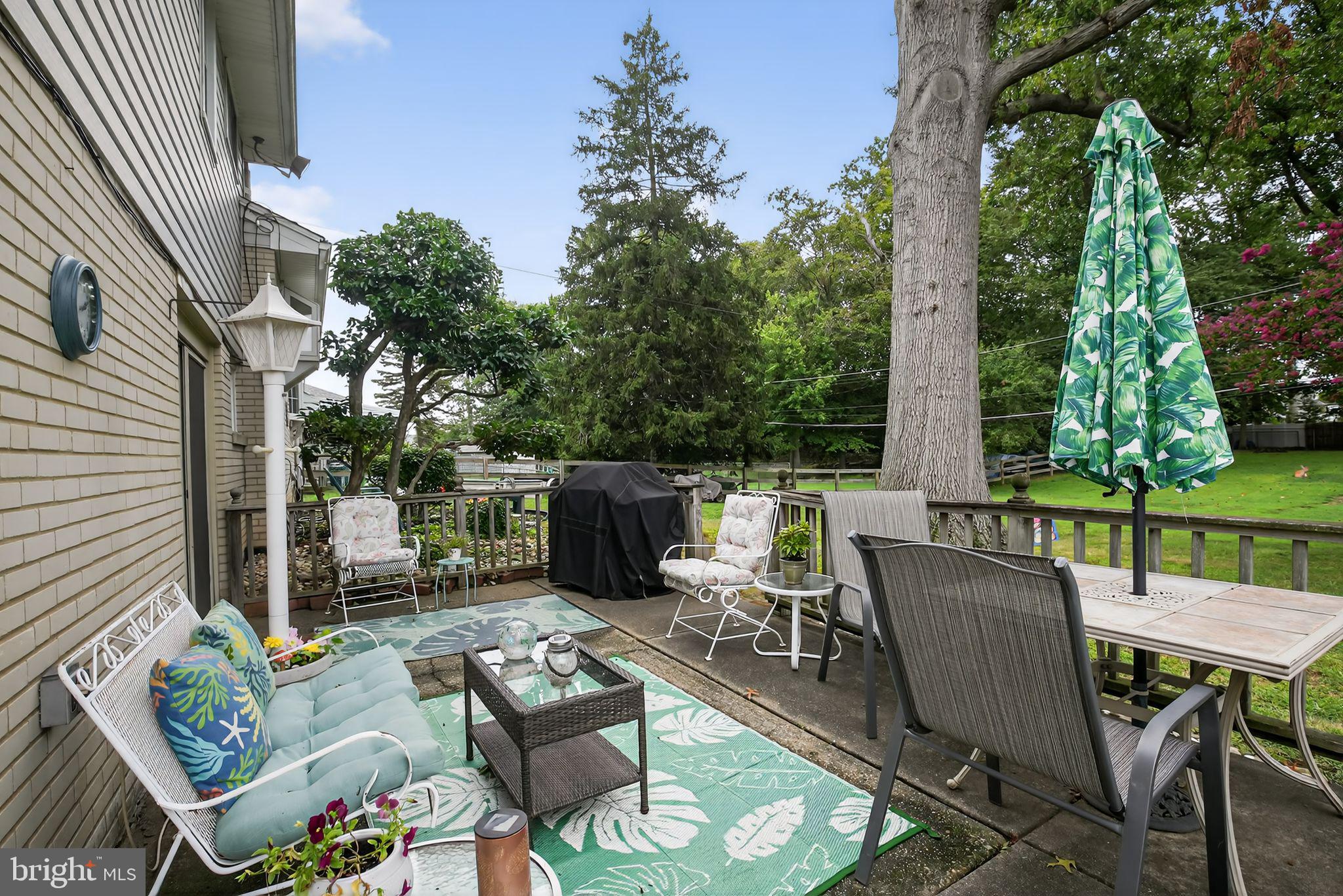 1009 Twist Road Philadelphia, PA 19115 - Photo 28 of 30 a view of a patio with a dining table and chairs with a fire pit