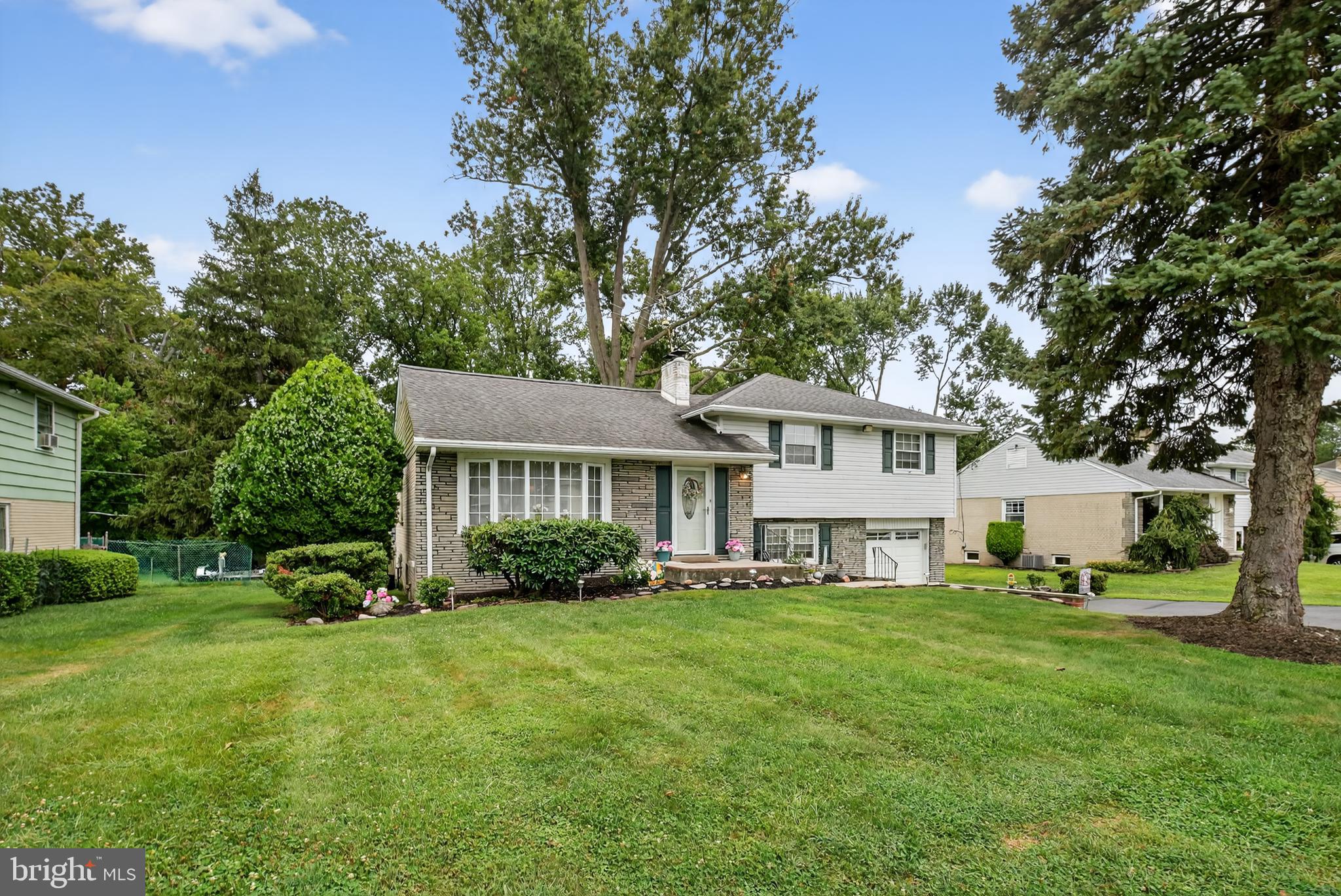 1009 Twist Road Philadelphia, PA 19115 - Photo 3 of 30 a front view of a house with a yard and trees