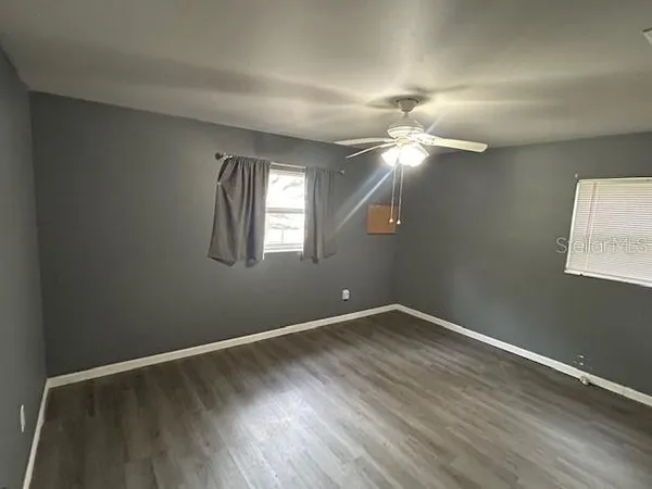 a room with a window and wooden floor