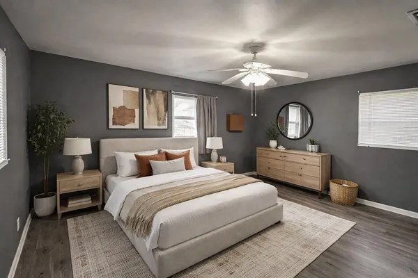 a bedroom with a large bed chandelier and a window